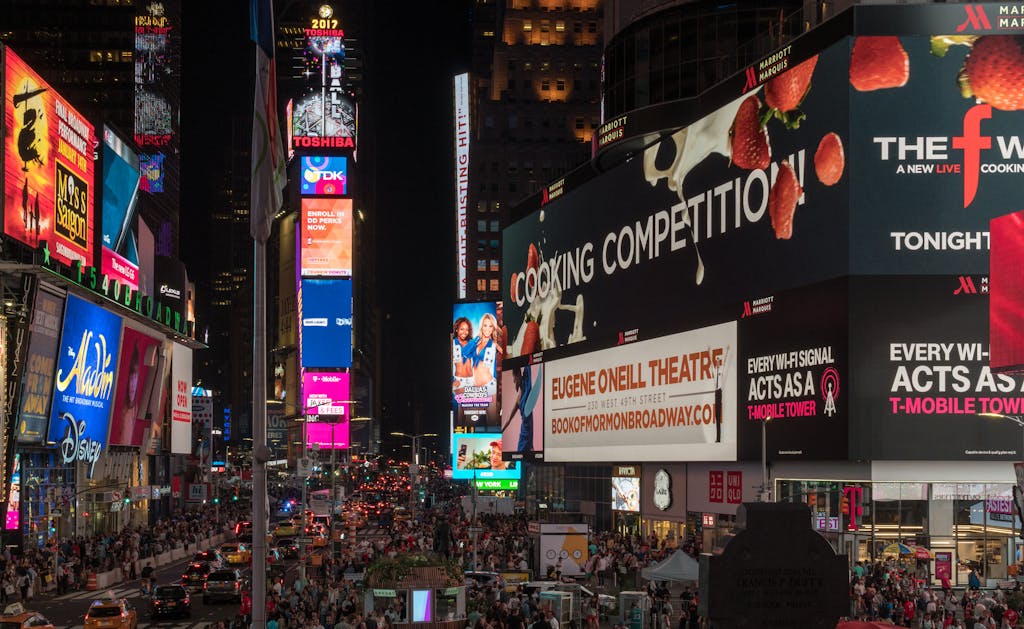 Times Square buzzing with nightlife, neon signs, and crowds in New York City.